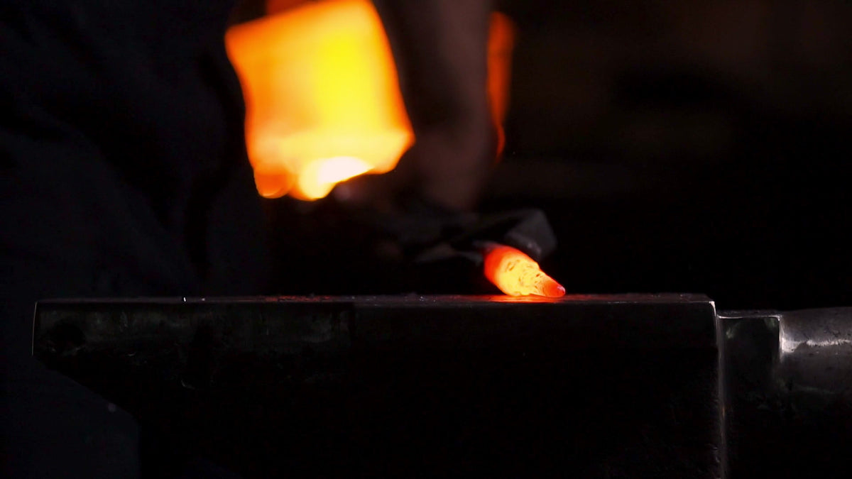 Blacksmith hitting an anvil and then a sun coming out behind the Earth.